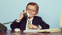 child in business suit answering the phone