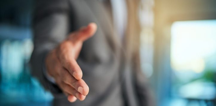 Cropped shot of a businessman extending his arm for a handshake