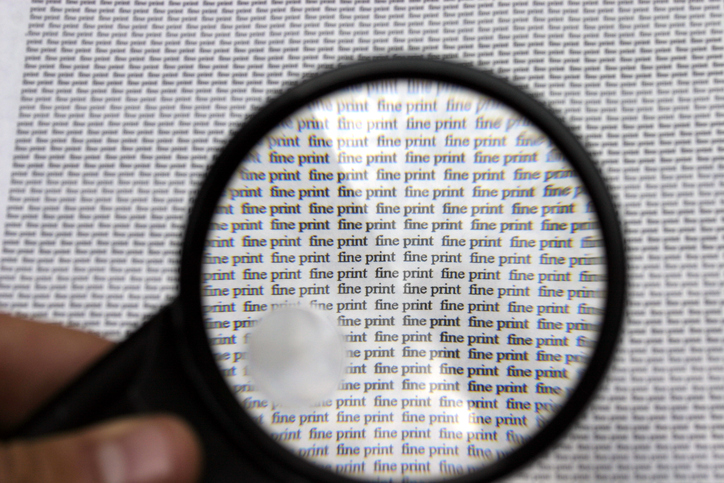 magnifying glass held over page that reads fine print